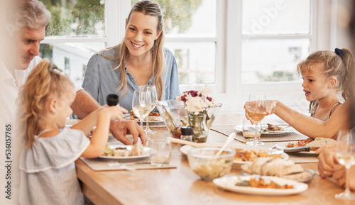 Love, food and family eating at table, relaxing and sharing a meal in their family home together. Children, mother and loving grandparent bonding and talking, hungry and excited for healthy lunch