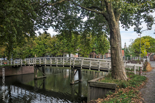 Enkhuizen, The Netherlands, October 4, 2022: wooden pedestrian bridge across a canal in Boerenhoek neighbourhood