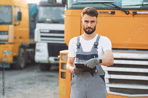 Man in unifrom doing service for big truck vehicle