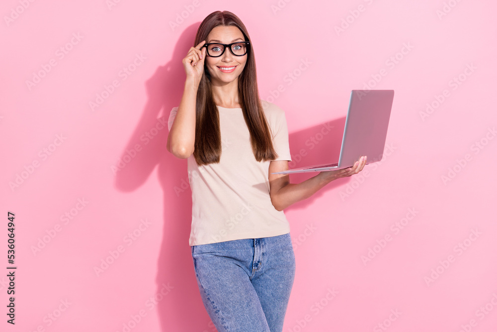Photo of charming adorable cute nice businesswoman touch her new glasses positive hold computer positive entrepreneur isolated on pastel pink color background Photo of charming adorable cute nice businesswoman touch her new glasses positive hold computer positive entrepreneur isolated on pastel pink color background