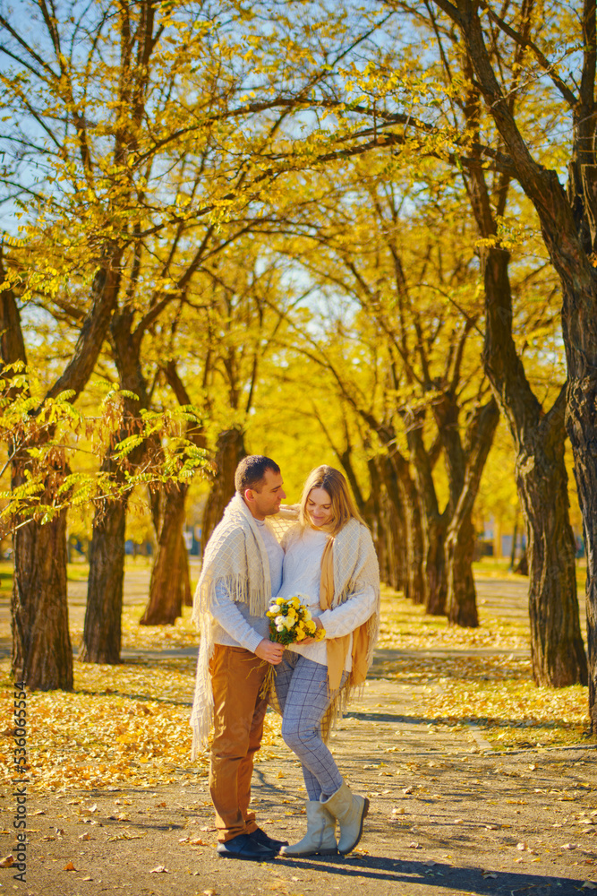 Pregnant woman and man at sunny warm autumn park Pregnant woman and man at sunny warm autumn park