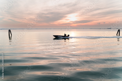 early morning fisher riding his boat to catch some fish © czphoto