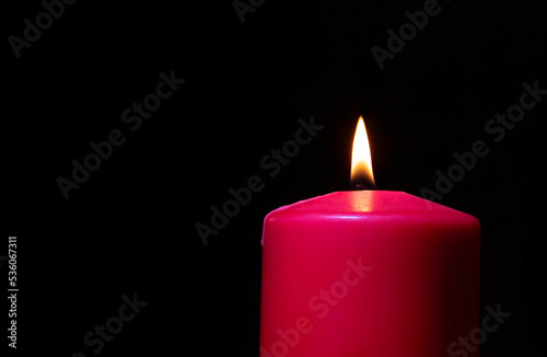 Candle lit on a black background