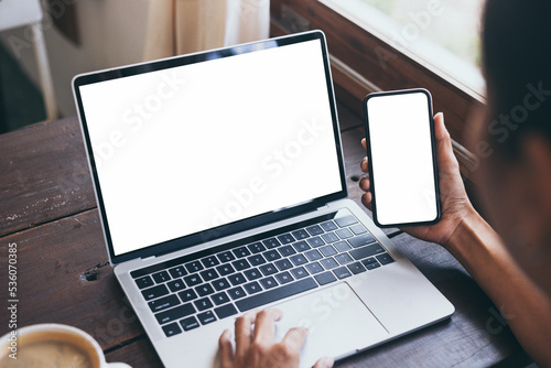 computer screen,cell phone blank mockup.hand woman work using laptop texting mobile.white background for advertising,contact business search information on desk in cafe.marketing,design