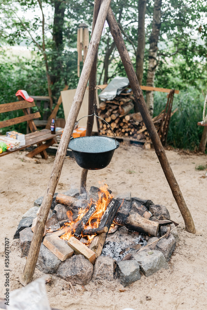 cooking food over a fire in a pot cooking food over a fire in a pot