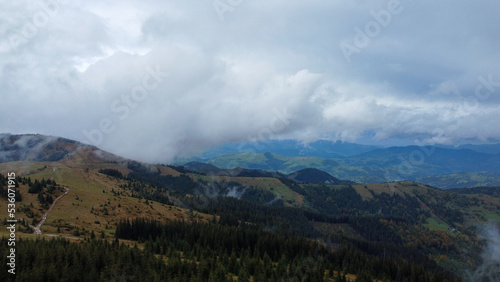 Panorama of forest covered by low clouds. Autumn rain and fog on the mountain hills. Misty fall woodland. © Oleksandr Matsibura