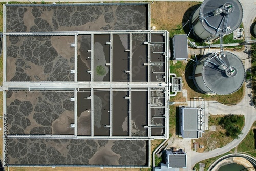 Aerial view of aeration tanks or activated sludge units, part of a water cleaning facility, at urban wastewater treatment plant photo