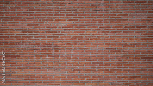 Texture of the wall of thin long red bricks