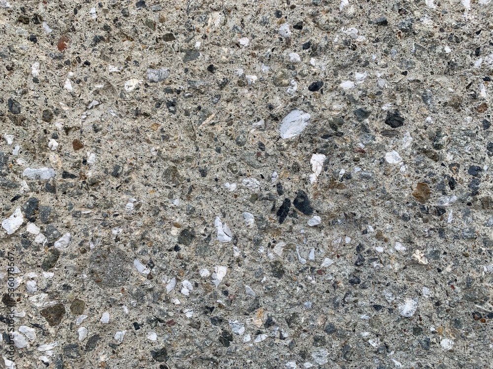 The cement background consists of sand and gravel.