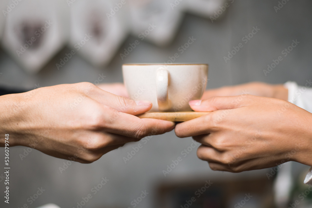 Close-up of hand Asian male barista serving coffee to customers in coffee shop Coffee business owner and coffee shop concept Close-up of hand Asian male barista serving coffee to customers in coffee shop Coffee business owner and coffee shop concept