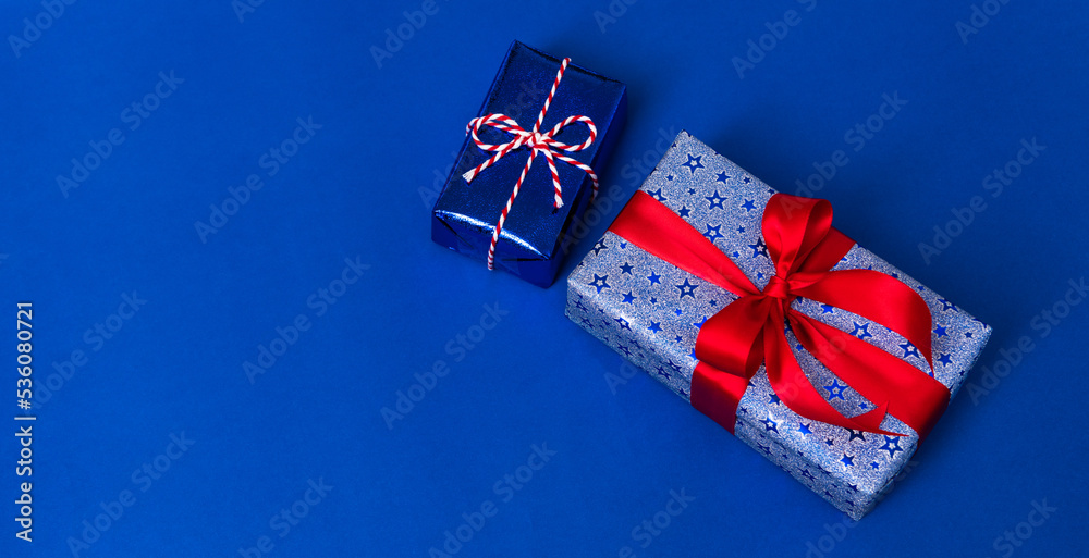 Fototapeta premium Happy Veterans Day concept. American flags with gift box against a blackboard background. November 11.