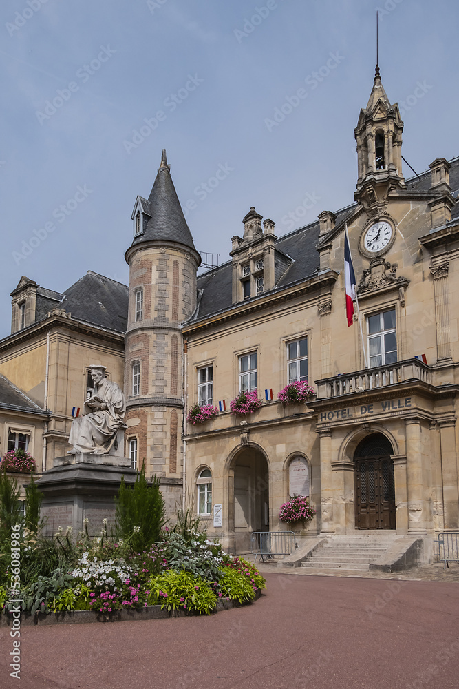 Famous historical Melun Town Hall (Hotel de Ville, 1846 - 1848). Town Hall combining neoclassical and neo-Renaissance styles, decorated with flags and flowers. Melun, France. 