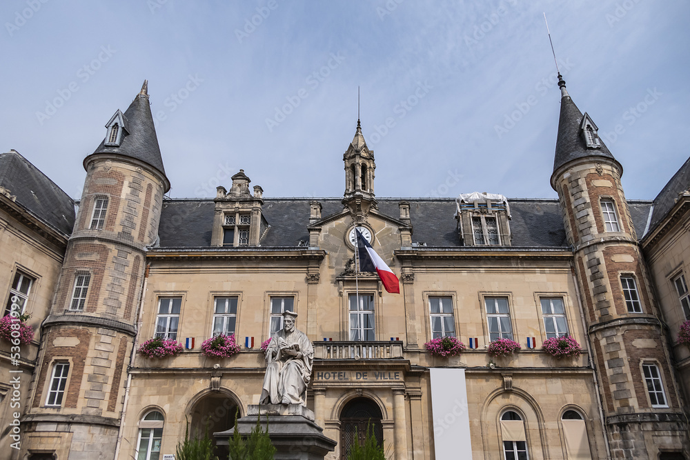 Fototapeta premium Famous historical Melun Town Hall (Hotel de Ville, 1846 - 1848). Town Hall combining neoclassical and neo-Renaissance styles, decorated with flags and flowers. Melun, France. 