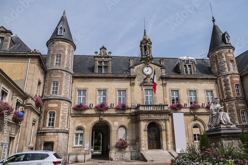 Famous historical Melun Town Hall (Hotel de Ville, 1846 - 1848). Town Hall combining neoclassical and neo-Renaissance styles, decorated with flags and flowers. Melun, France.  photo