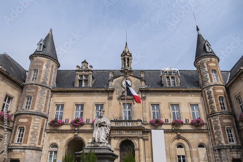 Famous historical Melun Town Hall (Hotel de Ville, 1846 - 1848). Town Hall combining neoclassical and neo-Renaissance styles, decorated with flags and flowers. Melun, France. 