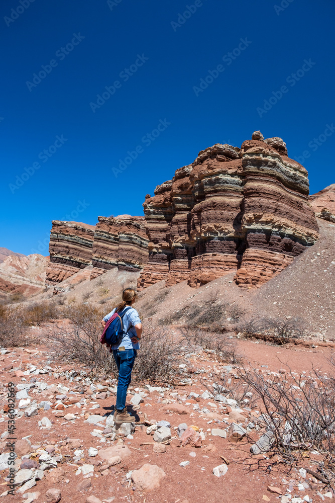 Woman walking in the colourfull mountain