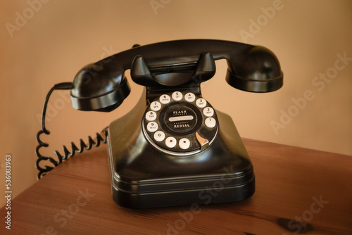 Vintage telephone on a wooden desk