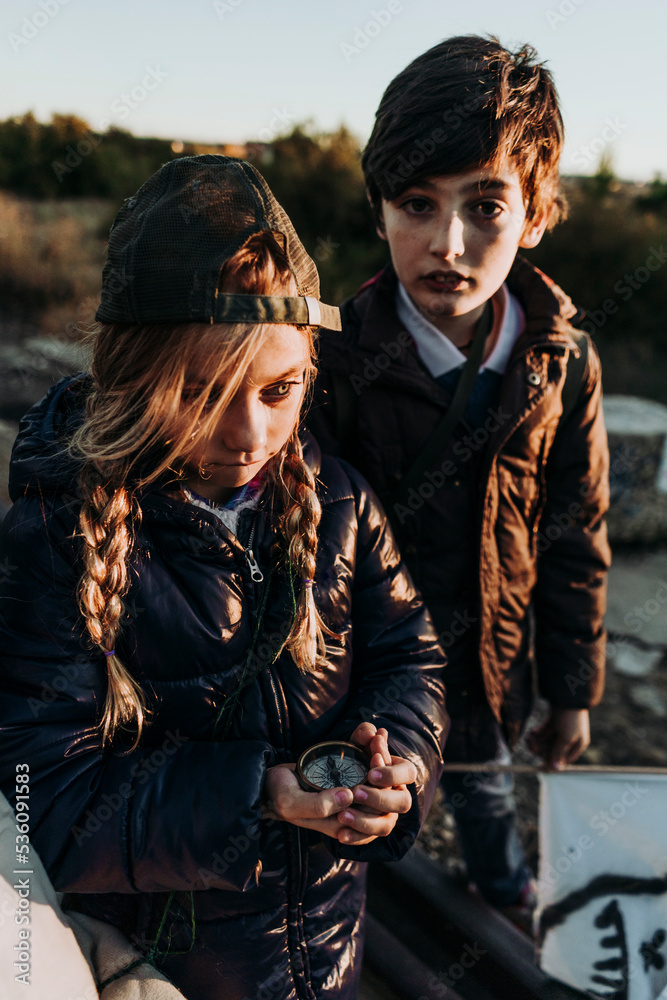 children on forest looking a compass children on forest looking a compass