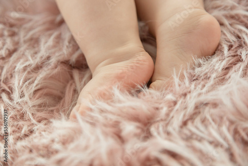 Baby's foot closeup on pink fluffy rug , New family and baby healthy concept.