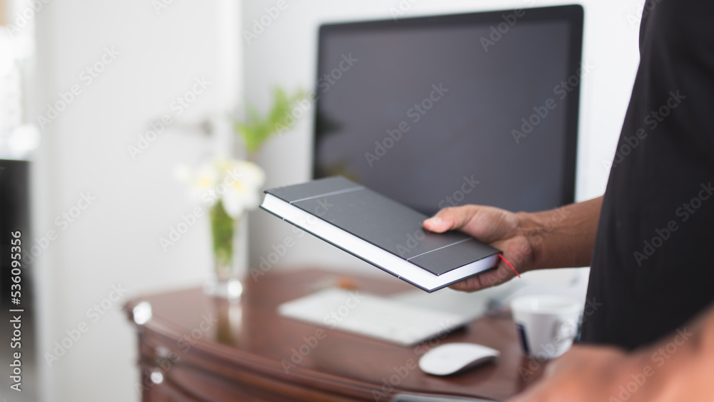 Fototapeta premium man looking at his work schedule in front of computer