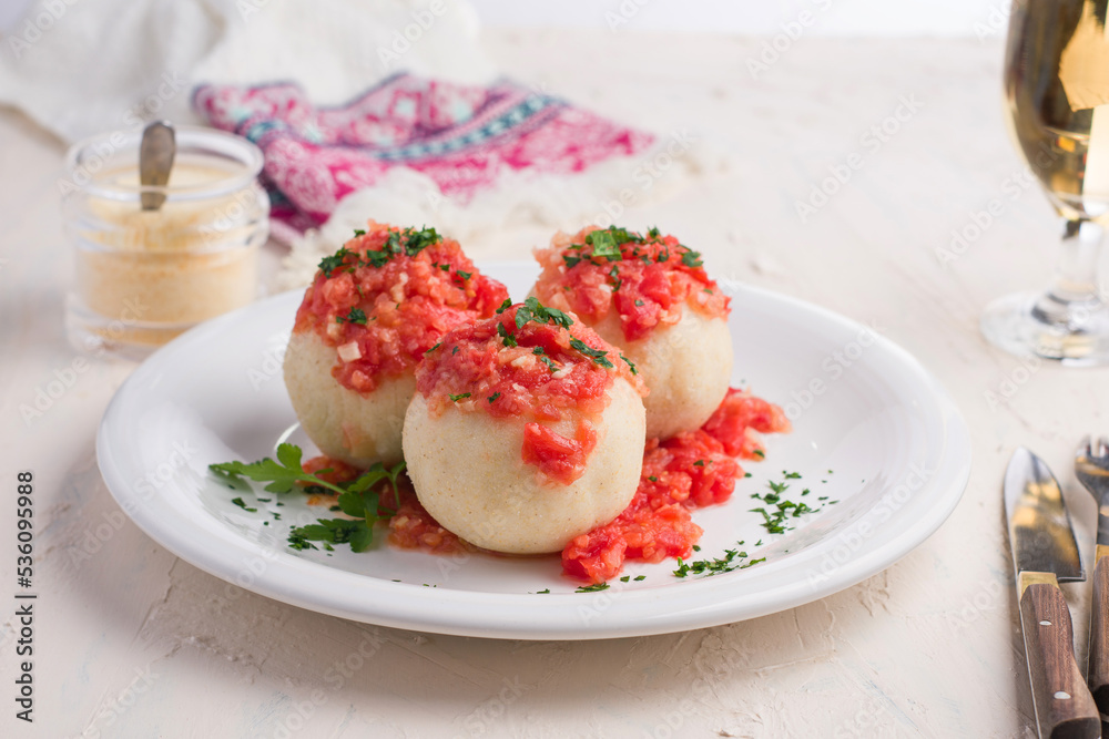 Delicious dish with tomato sauce and chopped greens Delicious dish with tomato sauce and chopped greens