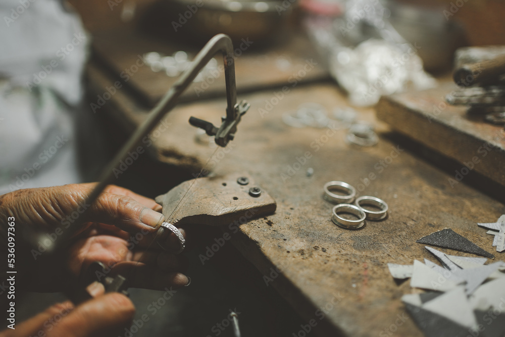 Jeweler at work in jewelry. Desktop for craft jewelry making with professional tools. Close up view of tools. Thailand. Jeweler at work in jewelry. Desktop for craft jewelry making with professional tools. Close up view of tools. Thailand.