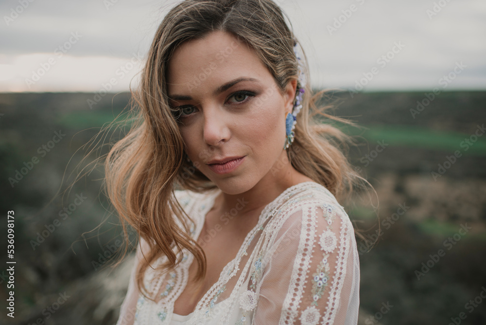 Charming woman in dress on field