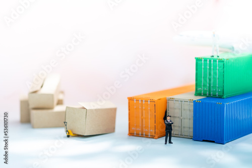 Miniature people: Businessman on container airplane with copy space for text using as background transportation logistic business concept.