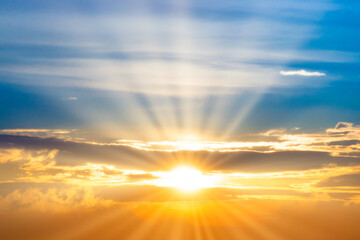 Sunset sky with sun rays and sunset clouds