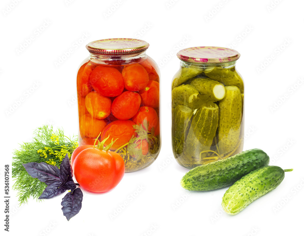 Preserved, pickled red tomatoes and cucumbers in a glass jar and fresh tomato, basil, dill, cucumber, isolated on white background Preserved, pickled red tomatoes and cucumbers in a glass jar and fresh tomato, basil, dill, cucumber, isolated on white background
