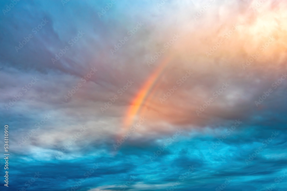 rainbow over Cumulus and cirrus cloudy dramatic gloomy sky before evening thunderstorm rainbow over Cumulus and cirrus cloudy dramatic gloomy sky before evening thunderstorm