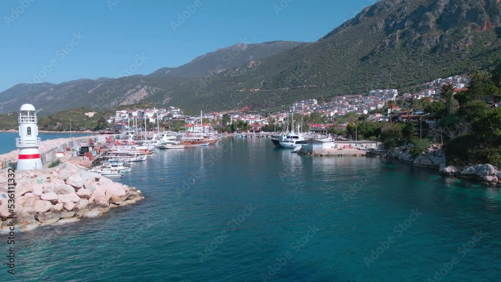 Yacht bay near the white lighthouse, near the city surrounded by mountains 4k Yacht bay near the white lighthouse, near the city surrounded by mountains 4k