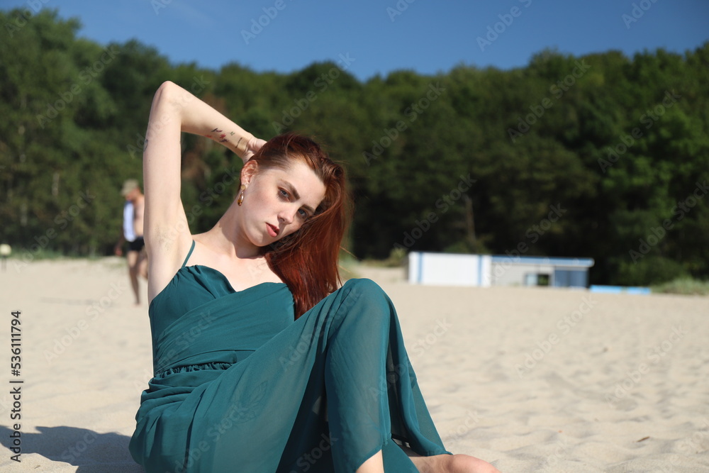 beautiful girl in a dress on the beach