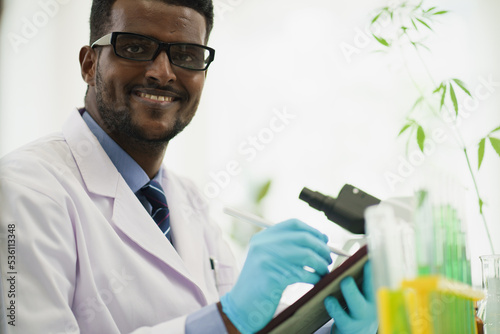 Scientist or biology researcher smiling to camera while working in the lab