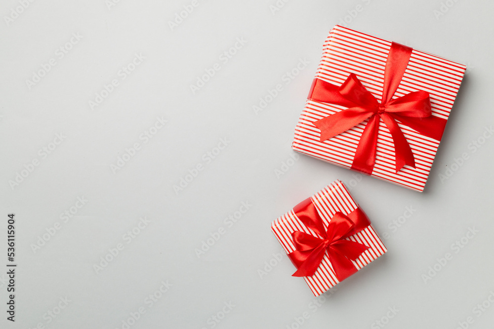 Obraz premium Christmas gift boxes on color background, top view