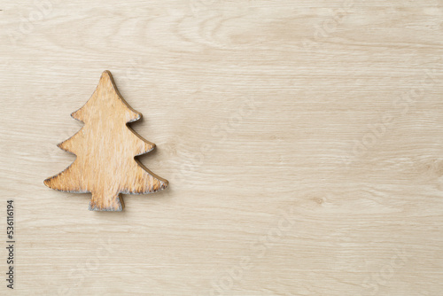 Wooden Christmas tree on wooden background, top view