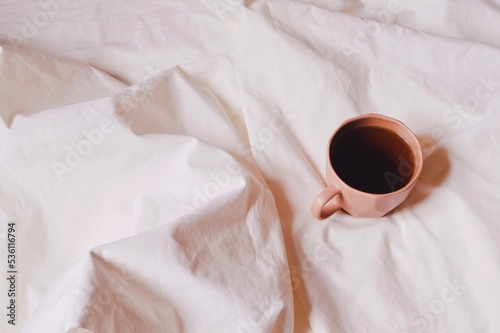 Brown cup of coffee top view photo. Good morning. Breakfast in bed. Warm home in winter