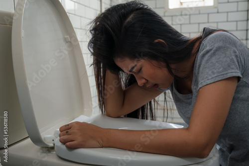 Woman drunk and vomit in bathroom photo