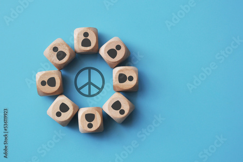 фотографія An image of a circle of people with a peace symbol in the center