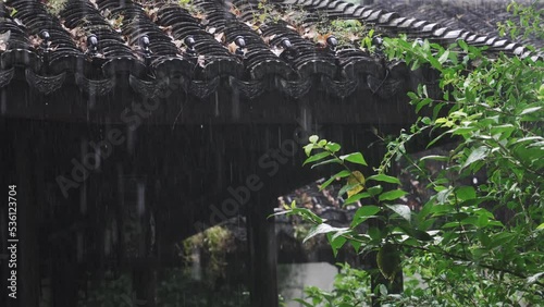 water drops from ancient architecture in rain photo