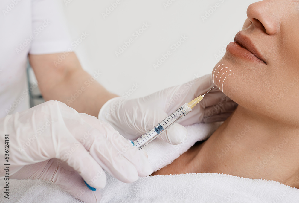 Facelift woman chin and lower face using beauty injection, non surgery. Process lifting face contour at cosmetology, close-up Facelift woman chin and lower face using beauty injection, non surgery. Process lifting face contour at cosmetology, close-up