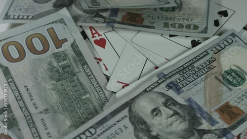 Wallpaper Mural $100 Bills Cascade Onto Playing Cards Rotating White Background 4K Torontodigital.ca