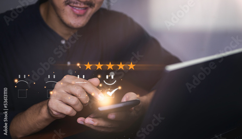 smart businessman use smartphone choosing happy smile face icon. feedback rating and positive customer review experience, satisfaction survey. world mental health day concept. soft focus.