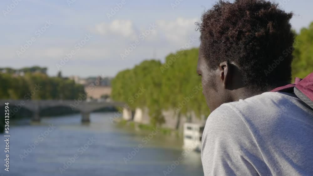black man with backpack by bridge thinking about life looking at hopeful black man with backpack by bridge thinking about life looking at hopeful