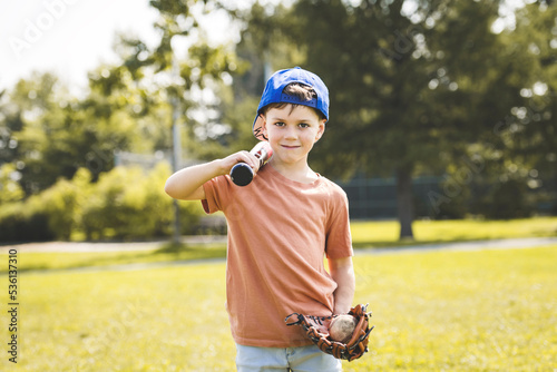 Photography Young boy with blue baseball cap on a field
