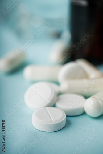 various medicines on a blue paper background