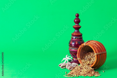 Laxmi puja essentials for rituals kept together. rice paddy grains and other objects symbolizing goddess of riches and prosperity during laxmi puja or makar sankranti in west bengal.