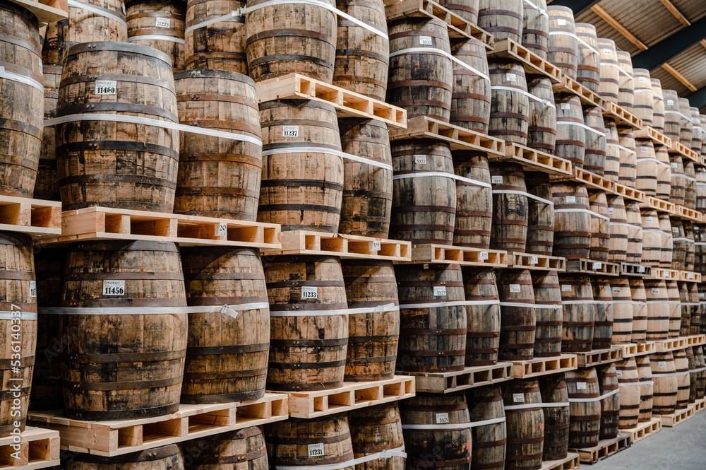 Stored oak barrels in the warehouse of a whisky distillery Stored oak barrels in the warehouse of a whisky distillery