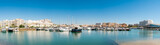 Panorama of luxury port of Vilamoura. Algarve region. Luxury travel destination in South of Portugal. Yacht docked, restaurants, luxury hotels and urbanisations