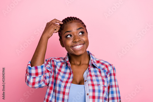 Portrait of creative minded girl finger scratch head look interested empty space isolated on pink color background